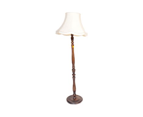 An early 20th century circa. 1920's mahogany floor standing standard&nbsp;lamp. The lamp having turned wood baluster shaft ov