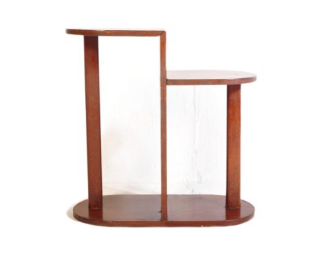 An early 20th Century 1930's&nbsp; Art Deco solid mahogany plant stand / shelving. Of asymmetrical form with semi circular st