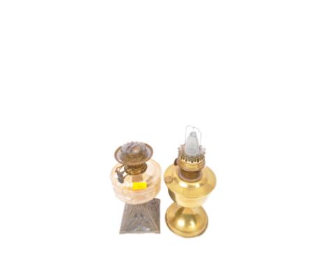 A 19th Century Victorian oil lamp. Having a glass reservoir (af) atop a cast iron pierced stand. Together with a 20th Century