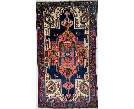 A 20th century Persian Islamic North West Viz flor rug carpet having central polychrome medallion of geometric form enclosed 