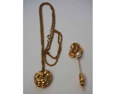 A 14 carat gold layered relief pendent, set on a 12 carat marked chain, 9g (gross); also a similar 14 carat gold and pearl se