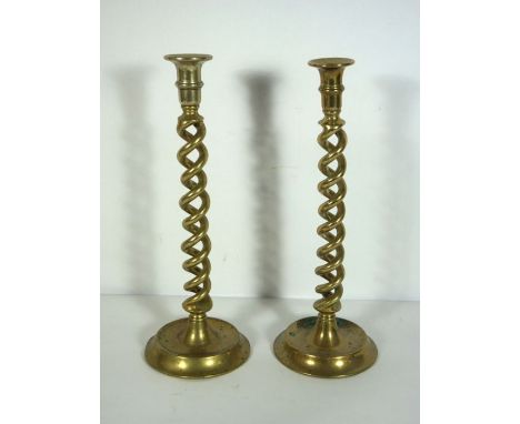 Two large double twist column brass candlesticks, 19th century, on dished bases, 35cm high; together with an oil lamp, a larg