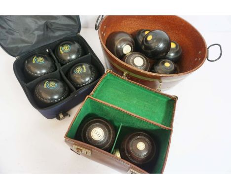 A set of four Edwardian lignum vitae turned lawn bowls, each with an ivory insert plaques numbered 1 & 2, including presentat