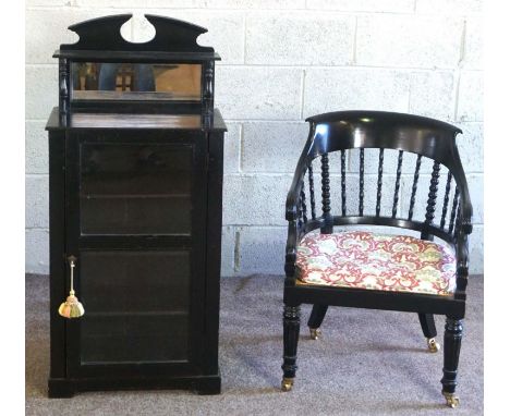 A Regency style ebonized bergere armchair, with bobbin turned back; together with a small Victorian ebonized side cabinet, wi