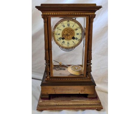 A decorative brass mantel clock by Mason of Paris with paste decorated dial and pendulum. With plinth. 15" high.