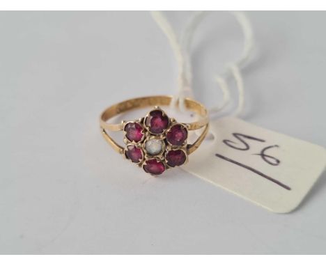 A Victorian gold garnet cluster ring hallmarked for 1857 size K