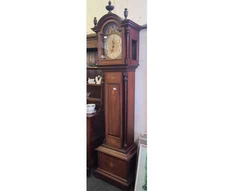 A good large Edwardian chiming long case clock with arched brass dial and bells.