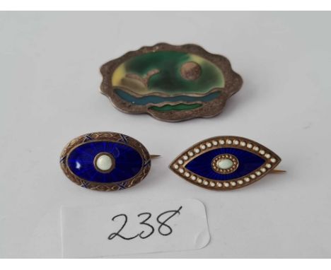 Three silver and enamel brooches
