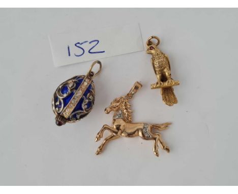 A silver and enamel fob in the form of a egg plus two 9ct charms in the form of a eagle and a horse (9.4 gms )