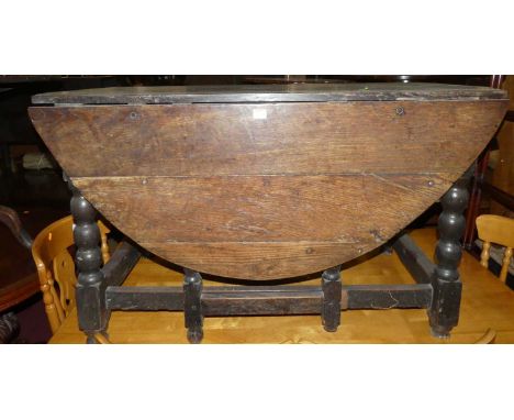 An 18th century joined oak gateleg dining table, raised on bobbin turned and square cut supports, with single end drawer, len