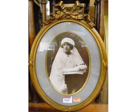 An early 20th century portrait photograph in gilt composition frame with ribbon surmount, height 36cm