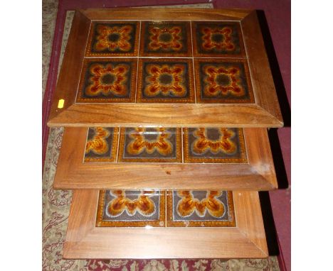 A 1970s teak and tile-top inset nest of three occasional tables, the largest w.58cm