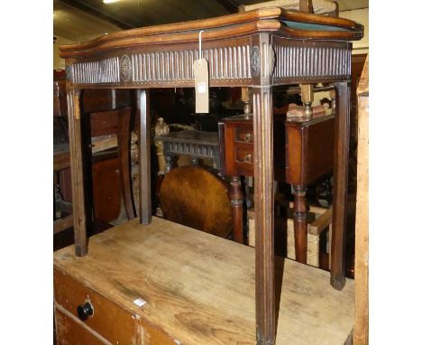 A George III mahogany serpentine front fold-over baize lined card table, having rear gateleg action and raised on fluted cham