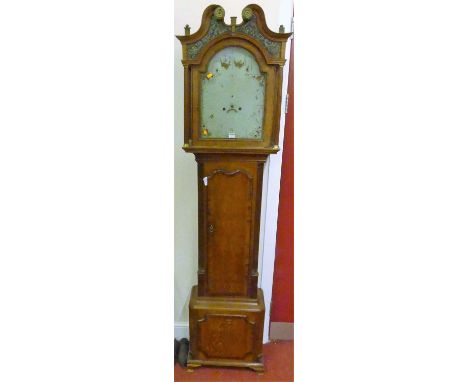 An early 19th century oak and mahogany crossbanded longcase clock, having a painted arched dial, with twin winding holes for 