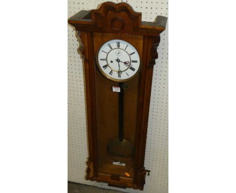 An early 20th century oak Vienna droptrunk wall clock, having a white enamel dial, pendulum, twin weights and winding key, h.