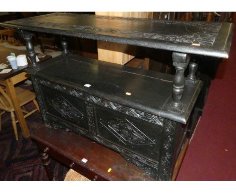 A circa 1900 ebonised and line carved oak fold-over monk's bench, having typical hinged boxseat base, w.121cm