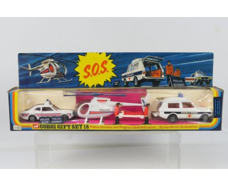 Corgi - Unsold Shop Stock - A boxed SOS set # GS18 with Ford Cortina Police car, Range Rover Ambulance and a Hughes 369 Helic