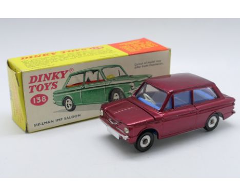 Dinky - Unsold Shop Stock - A boxed Hillman Imp Saloon # 138. This model in the rarer dark red finish appears Near Mint with 