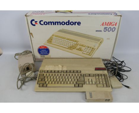 Commodore - A boxed vintage Commodore Amiga 500 PC. The computer comes with mouse plus power supply, and appears to be Fair P