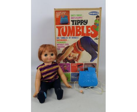 Remco - A boxed vintage Remco 'Tippy Tumbles' doll. The battery operated tumbling doll has a detached right leg, otherwise ap