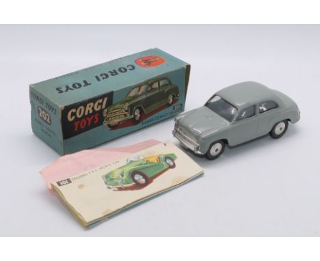 Corgi - A boxed Morris Cowley saloon # 202. The model appears in Very Good condition with a few small paint chips. There is a