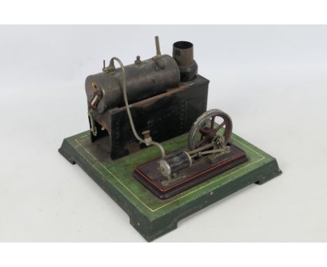 Bing - An unboxed vintage Bing live steam Single Cylinder Stationary Engine on a green metal base measuring 23.5 x 23.5 cm. T