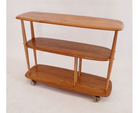 An Ercol retro blonde Giraffe No 361 trolley bookcase room divider on castors, 91cm long x 71cm high 