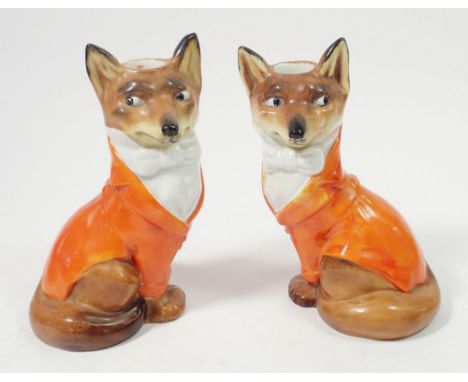 A pair of Royal Bayreuth fox candlesticks dressed as huntsmen, 16cm - one restored