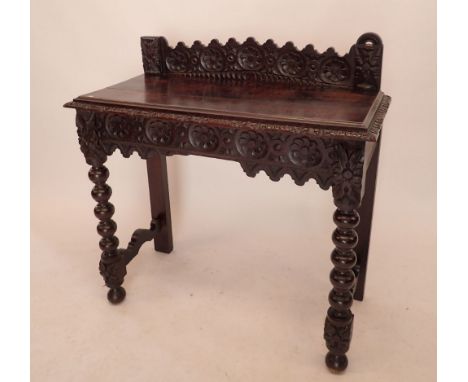 A Victorian oak Jacobean style hall table with all over carved decoration, end drawer and bobbin turned supports, 92cm 
