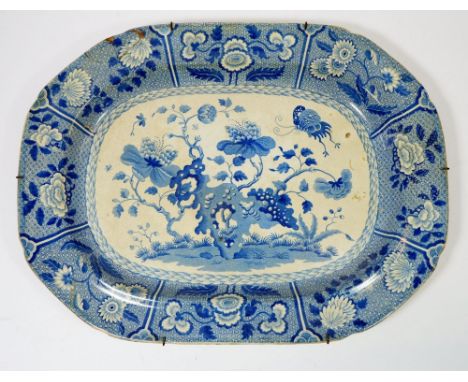 An early 19th century Spode blue and white meat plate decorated flowering trees and insects in deep floral border, 43cm wide 