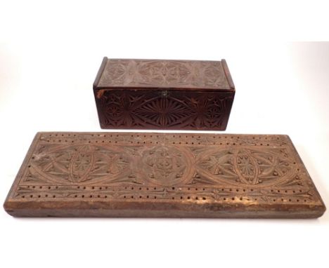 A large gothic design cribbage board, 45cm long together with a gothic carved wooden box 