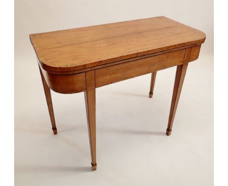 An early 19th century mahogany fold top card table on square tapered supports 