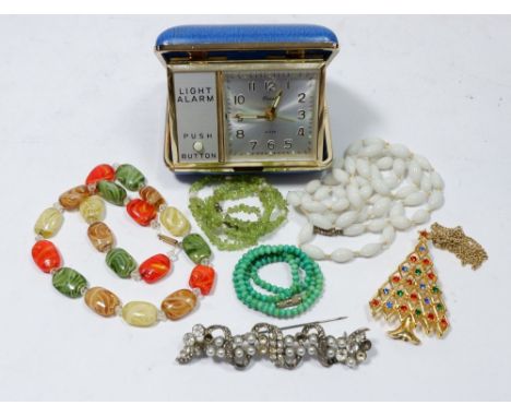 Various costume jewellery and a vintage coral travel alarm clock 