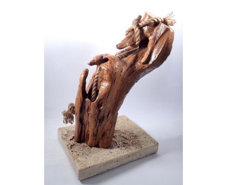 A natural carved wood and rope sculpture on stone base 