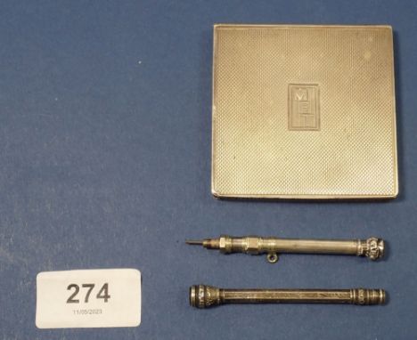 A silver compact London 1945 engraved 'MET' a silver pencil and a white metal one