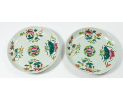 A pair of Chinese early 20th century famille rose saucers painted louts and other blossom, 17cm diameter with base mark