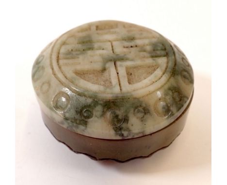 A Chinese circular jade box with carved lid 