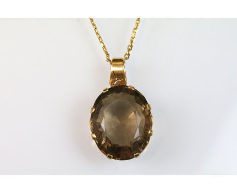 Vintage smoky quartz pendant necklace. The necklace set with an oval step cut smoky quartz to a 9ct gold chain. Chain marked 