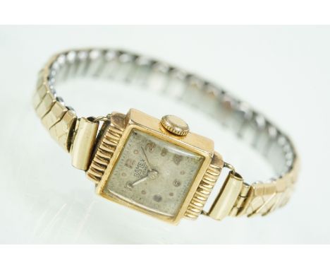 Ramex 18ct gold cased wrist watch having a square face with arabic numerals to the chapter ring set to a extending bracelet s