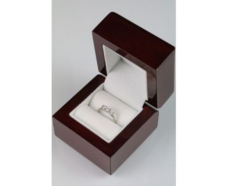 Platinum and diamond three stone ring. The ring being set with three round brilliant cut diamonds to the head. Hallmarked She