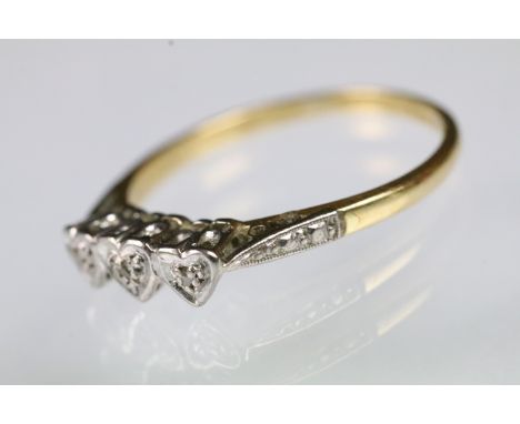 18ct gold and platinum and diamond three stone ring. The ring having three heart shaped settings to the head set with diamond