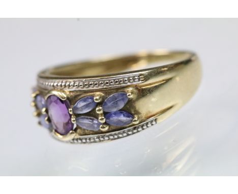 9ct white gold amethyst and tanzanite dress ring being set with an oval cut amethyst to centre flanked by marquise cut tanzan