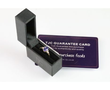 9ct gold tanzanite and diamond ring. The ring being set with an oval cut tanzanite with round and step cut diamond accent sto