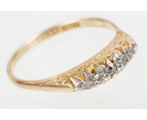 Early 20th Century 18ct gold and diamond ring set with five old cut diamonds in a scrolled setting. Marked 18ct. Size Q. 