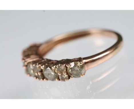 9ct gold champagne diamond ring being set with five brilliant cut diamonds and a further eight round cut diamond accent stone