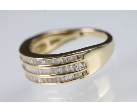 9ct gold and diamond ring being channel set with three rows of calibre cut diamonds. Hallmarked Sheffield. Size M. 