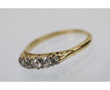 Early 20th Century diamond five stone ring. The ring being set with five graduating round cut diamonds. Band unmarked. Size N