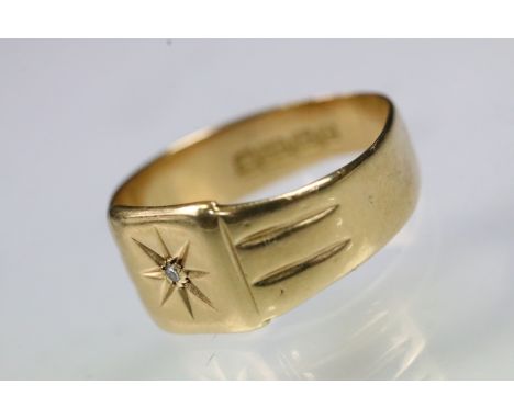 18ct gold and diamond ring having a square head with diamond set to the head with reeded shoulders. Hallmarked Birmingham 192