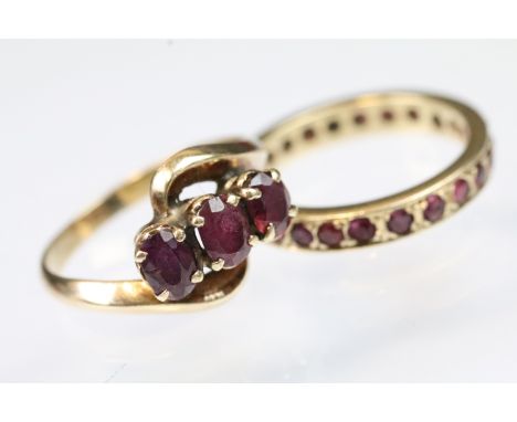 Two vintage ruby set rings to include a three stone crossover ring and a ruby eternity ring. Both unmarked, tests indicate 9c