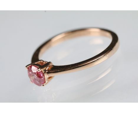 14ct rose gold and pink diamond solitaire ring. The ring being set with a round brilliant lab grown pink diamond in a four pr